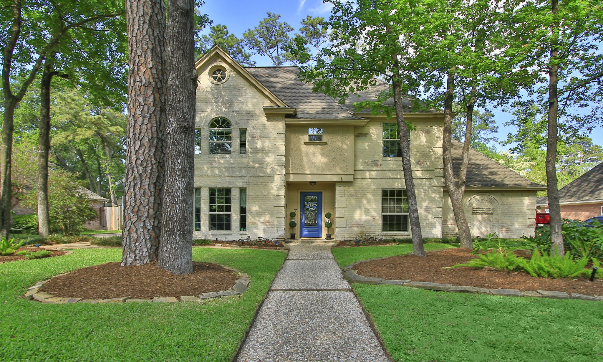 9546 Enstone Circle Spring, TX 77379 - Photo 2 of 44 A picturesque walkway leads to a striking front entry, highlighted by a bold accent door and classic architectural details. This home has all that Champion Forest charm!