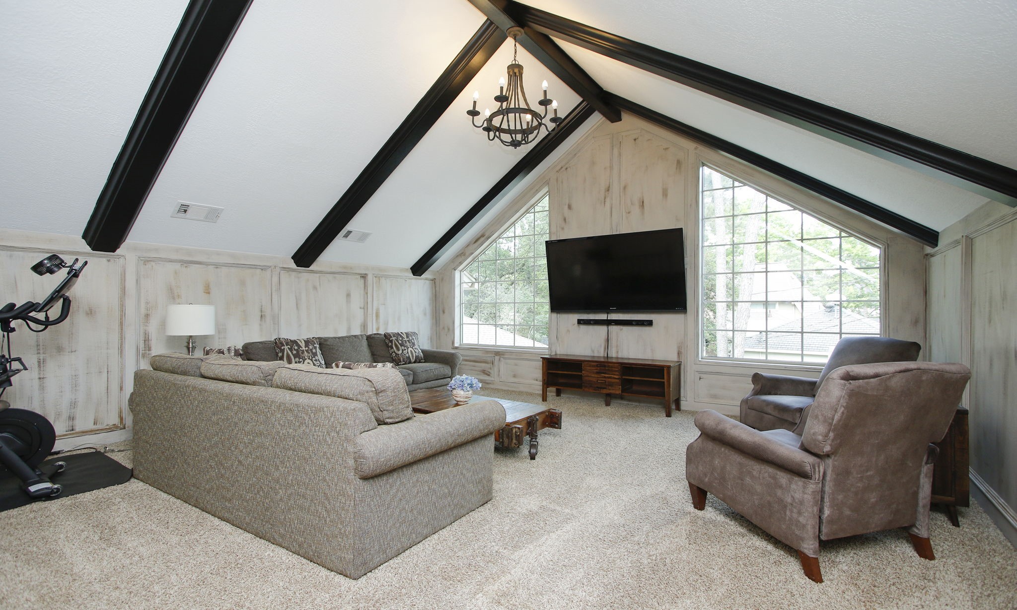 9546 Enstone Circle Spring, TX 77379 - Photo 31 of 44 The second floor game room has a vaulted ceiling with wood beams.