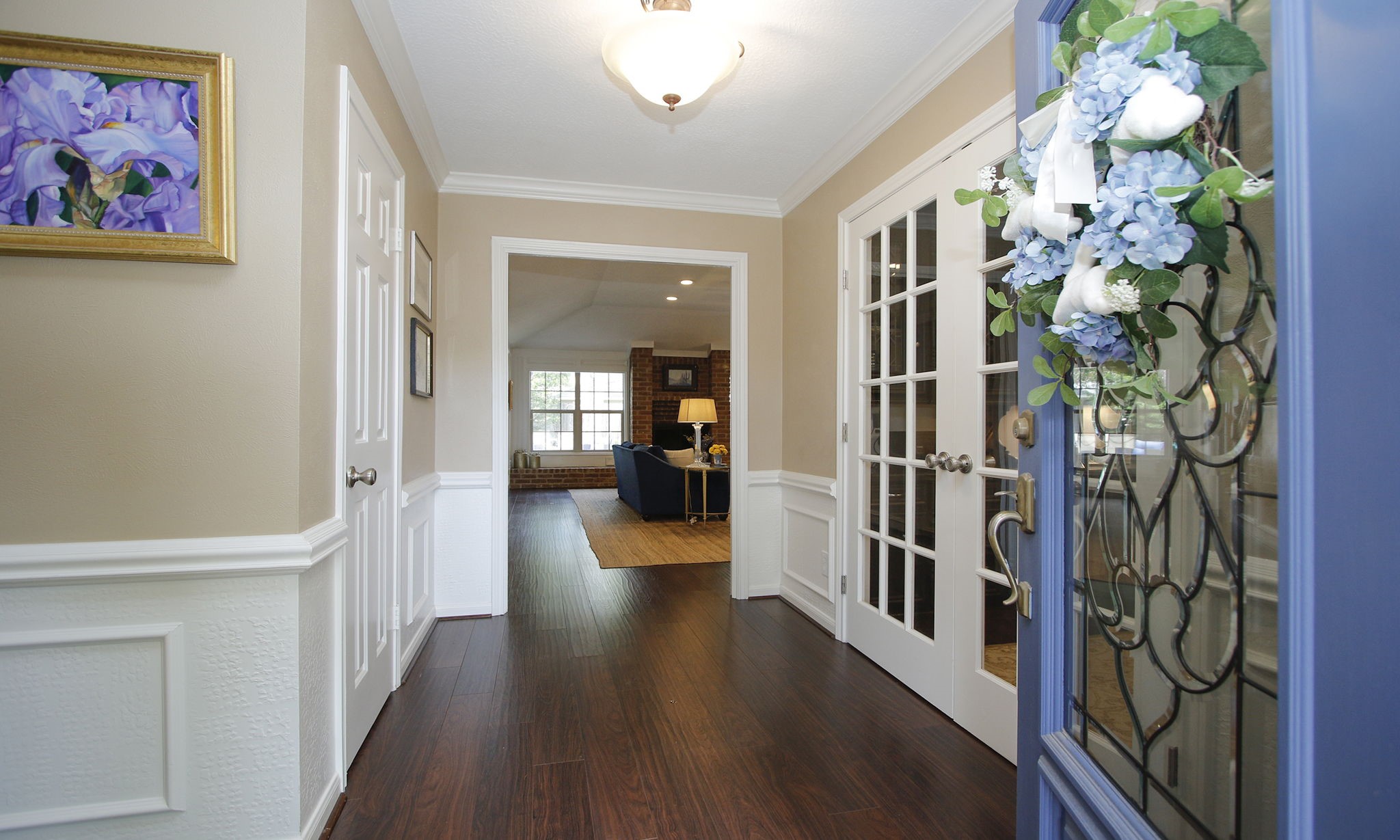 9546 Enstone Circle Spring, TX 77379 - Photo 5 of 44 a hallway with wooden floor and paintings on the walls