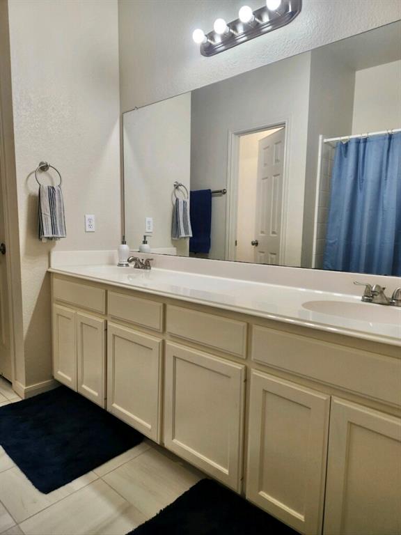 207 Kates Way Hutto, TX 78634 - Photo 8 of 24 Double vanity with ample counter space, integrated sinks, and neutral cabinetry