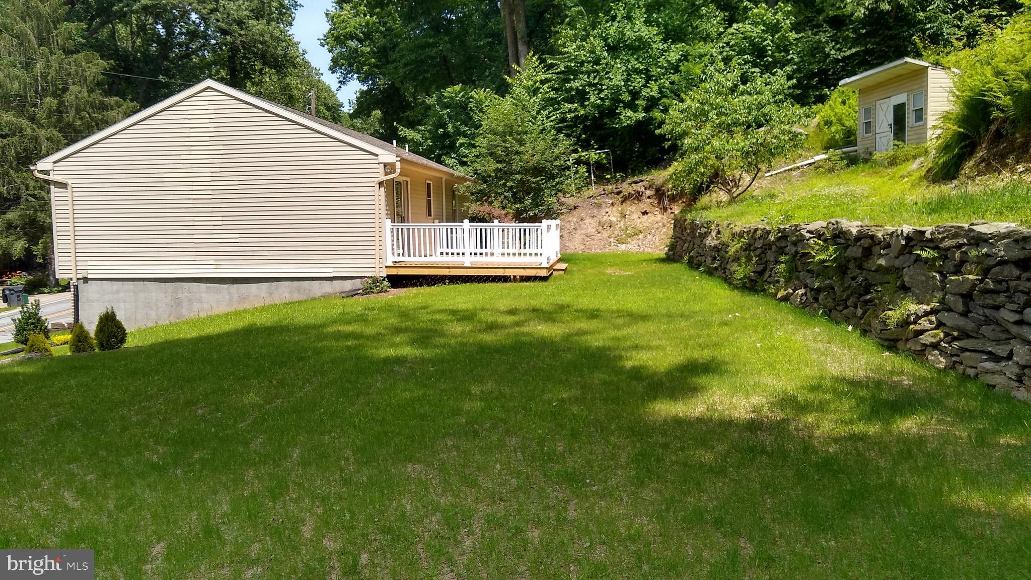 532 Bridge Valley Road Pequea, PA 17565 - Photo 14 of 43 a view of a backyard with plants and large trees