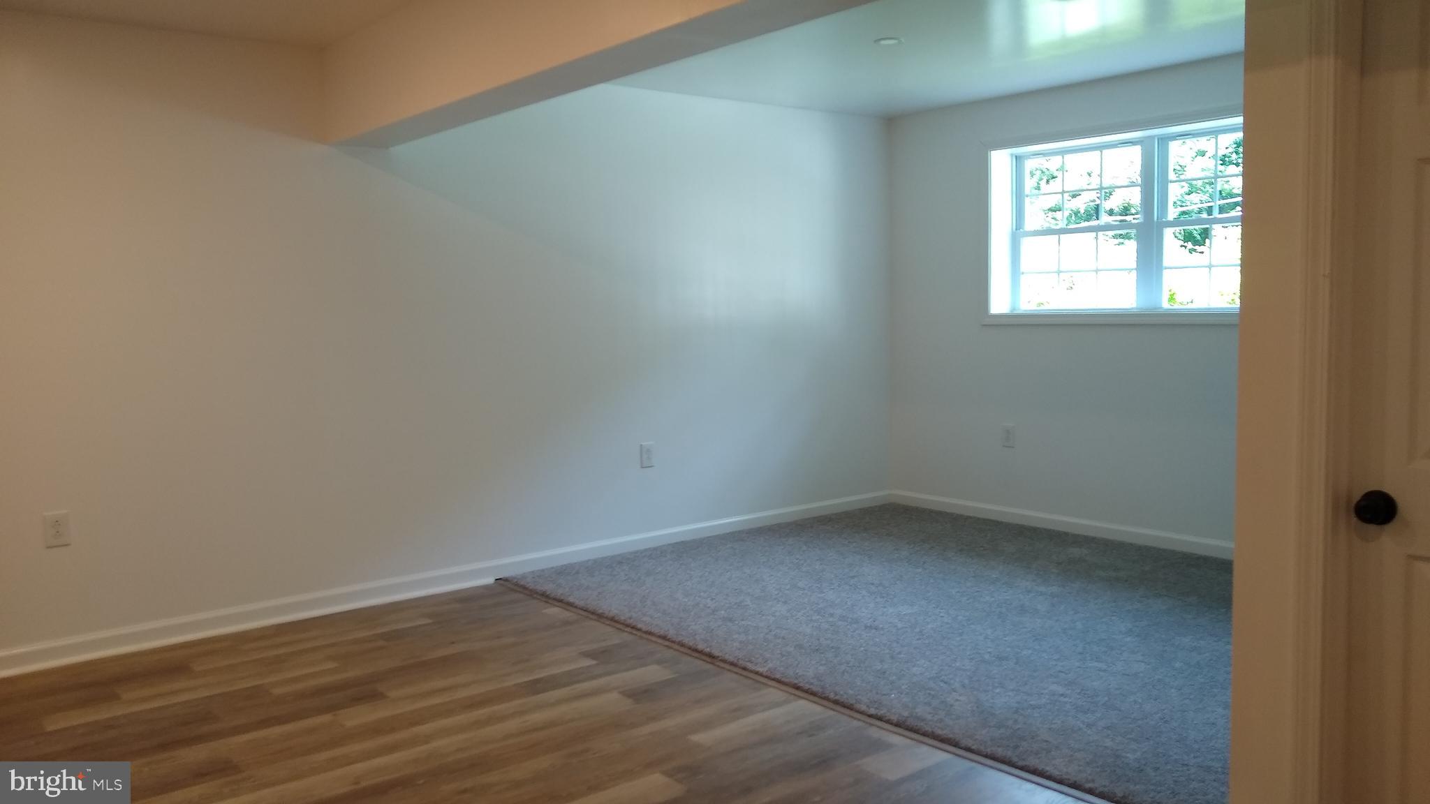 532 Bridge Valley Road Pequea, PA 17565 - Photo 10 of 43 an empty room with wooden floor and windows