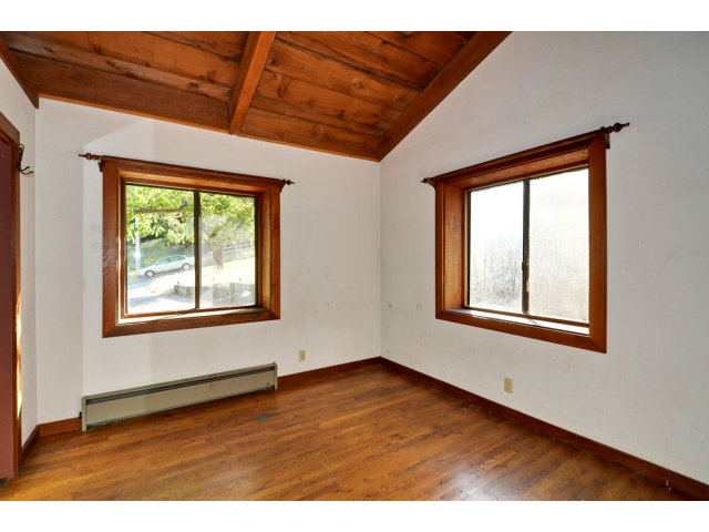 139 Bohnen Road Santa Cruz, CA 95065 - Photo 13 of 25 an empty room with wooden floor and windows