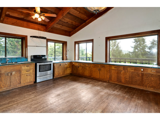 139 Bohnen Road Santa Cruz, CA 95065 - Photo 17 of 25 a large kitchen with granite countertop a stove a sink and a dishwasher with wooden floor