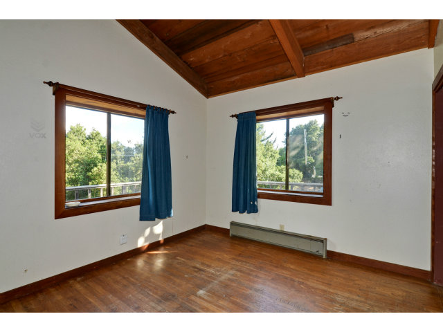 139 Bohnen Road Santa Cruz, CA 95065 - Photo 10 of 25 a view of an empty room with wooden floor and a window