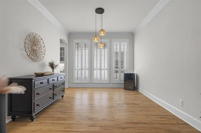 a kitchen with stainless steel appliances a white center island and a wooden floor