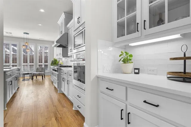 a open kitchen with stainless steel appliances granite countertop a lot of counter space and wooden floors