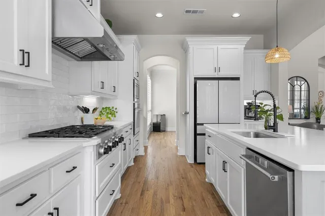 a kitchen with counter top space and wooden floor