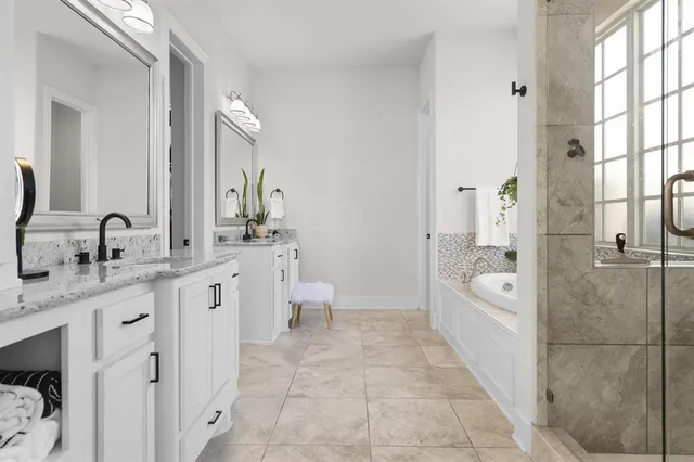 a bathroom with a granite countertop sink a toilet and shower