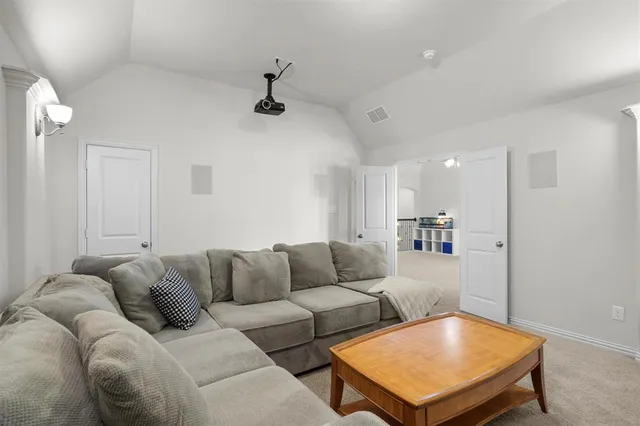 a bedroom with a bed and painting on the wall