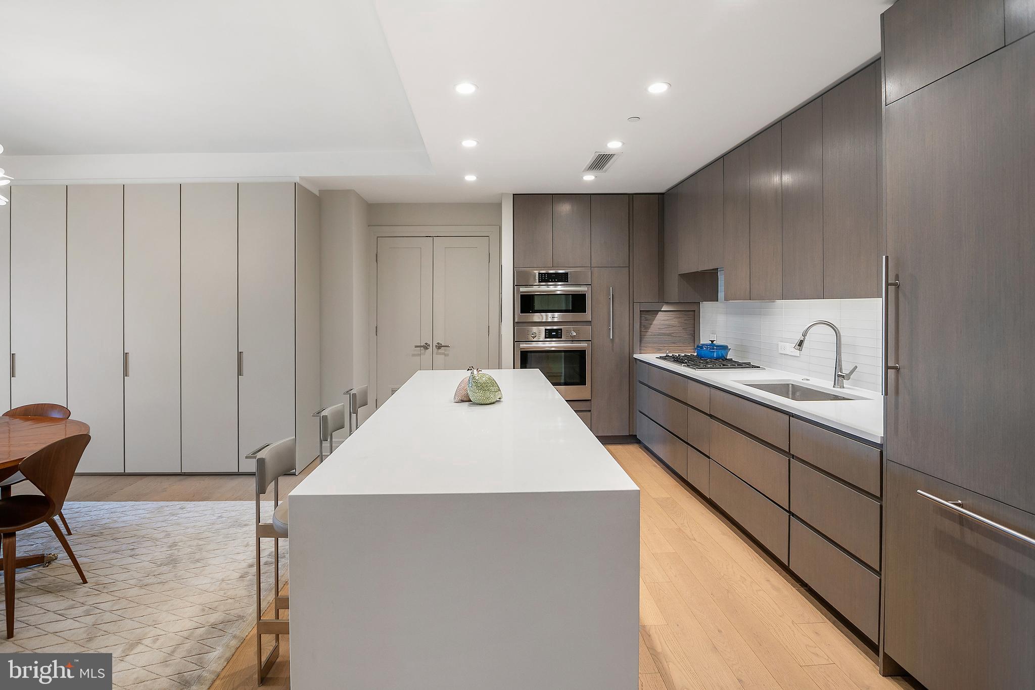 2501 M Street Northwest, Unit T12 Washington, DC 20037 - Photo 11 of 46 a kitchen with kitchen island a sink stainless steel appliances and cabinets