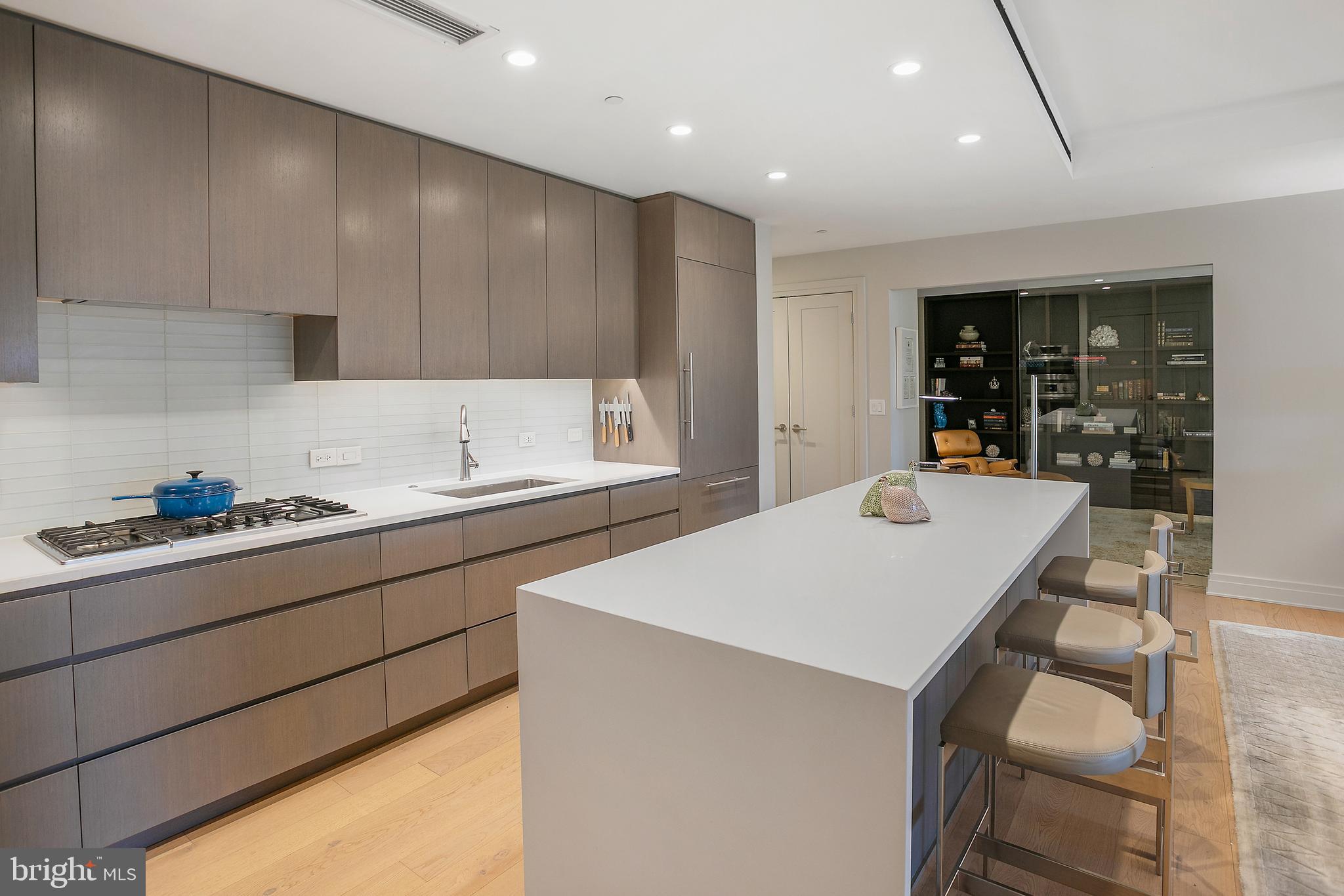 2501 M Street Northwest, Unit T12 Washington, DC 20037 - Photo 13 of 46 a kitchen with kitchen island a sink table and chairs