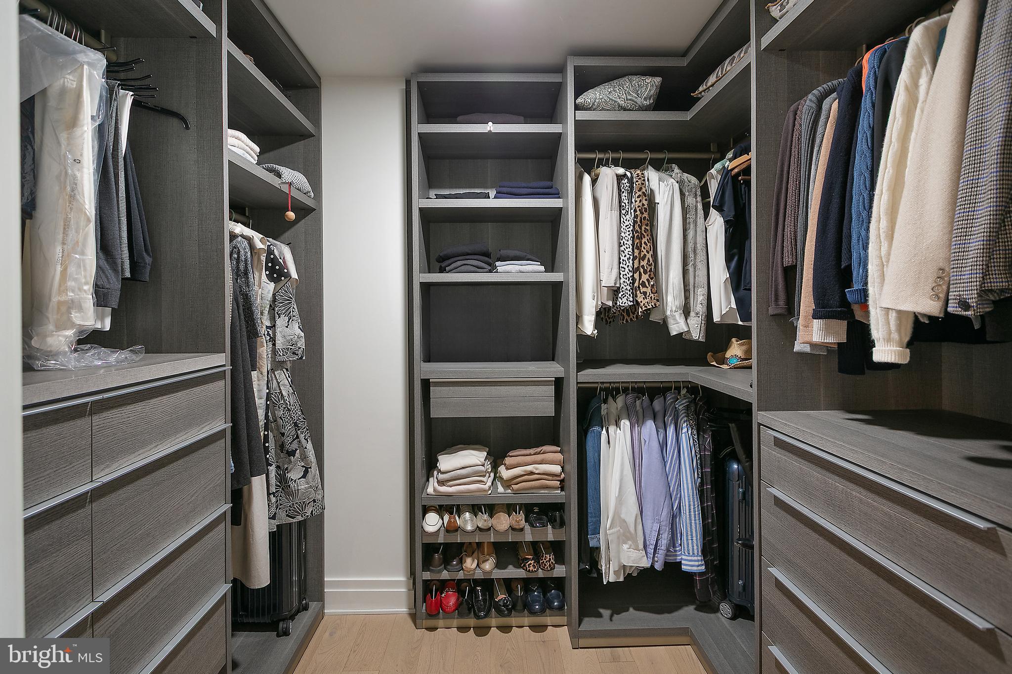 2501 M Street Northwest, Unit T12 Washington, DC 20037 - Photo 24 of 46 a view of walk in closet with clothes and shoes