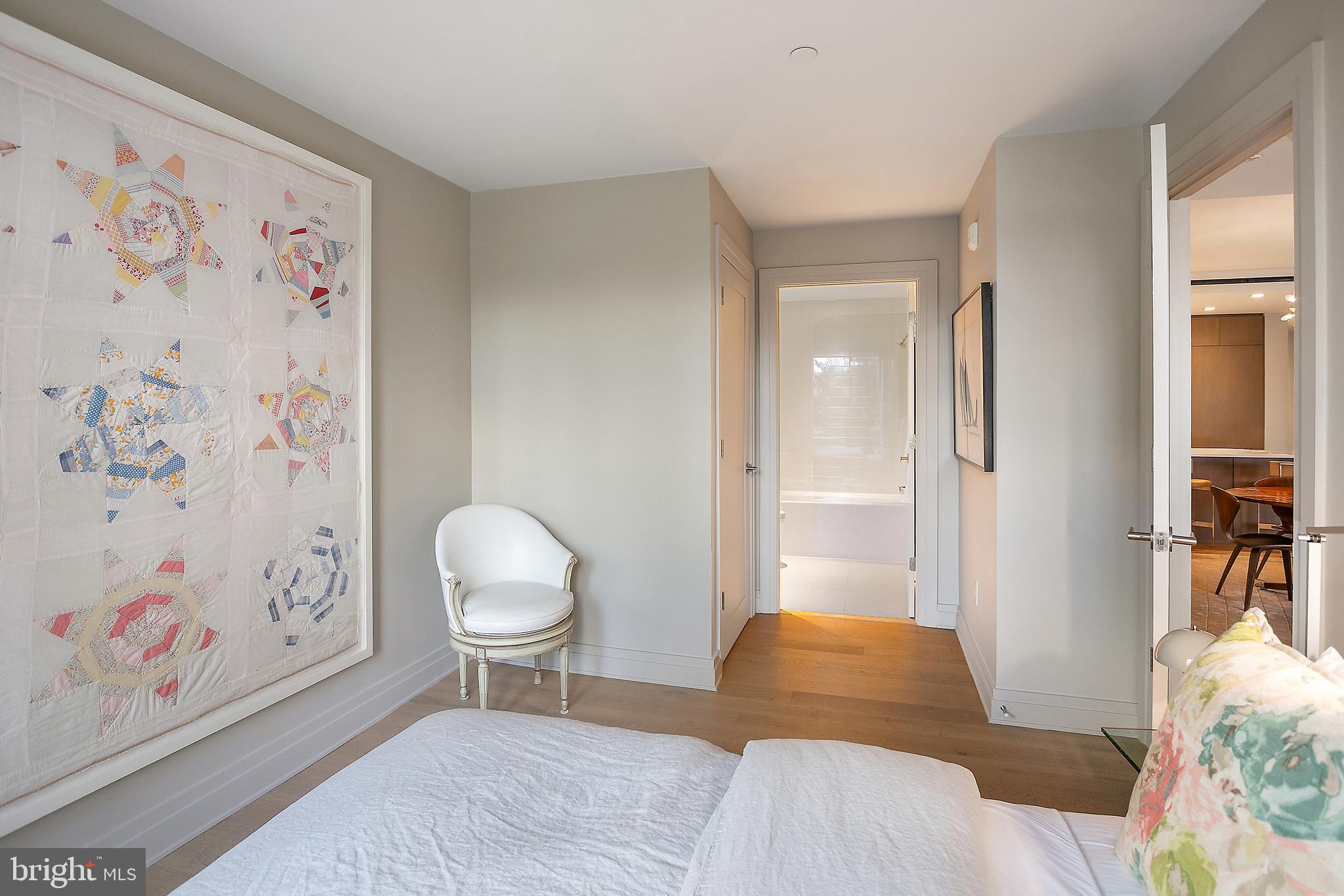 2501 M Street Northwest, Unit T12 Washington, DC 20037 - Photo 30 of 46 a bedroom with a bed and a painting on the wall