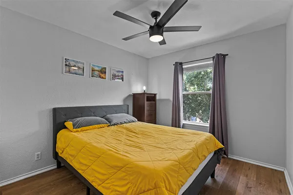 a bedroom with a bed and a large window