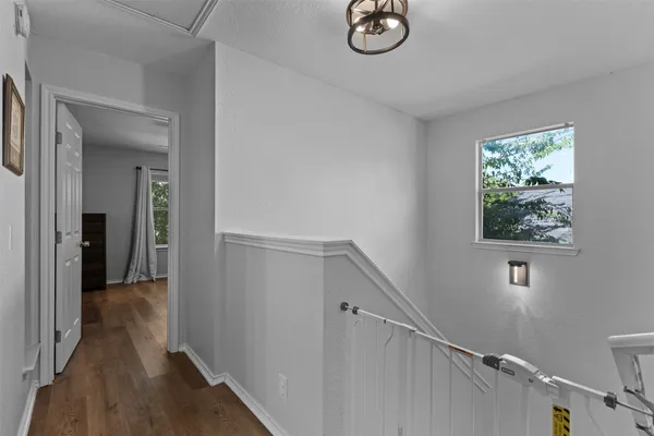 a view of a hallway with wooden floor