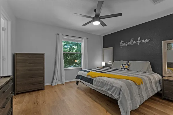 a bedroom with a bed and a ceiling fan