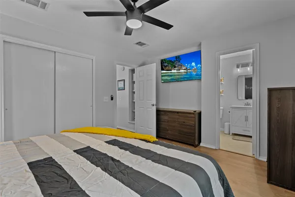 a bedroom with a bed and a flat screen tv