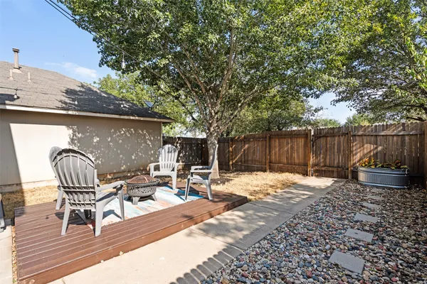 a backyard of a house with barbeque oven and outdoor seating