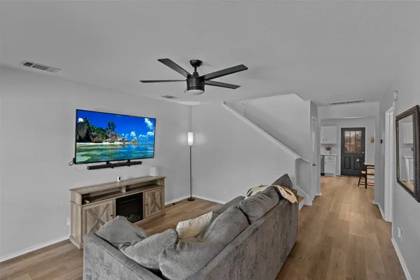 a living room with furniture and a flat screen tv