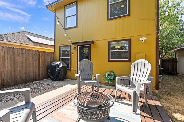 a view of a patio with a table and chairs