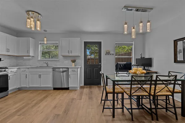 a kitchen with a table chairs stove and cabinets