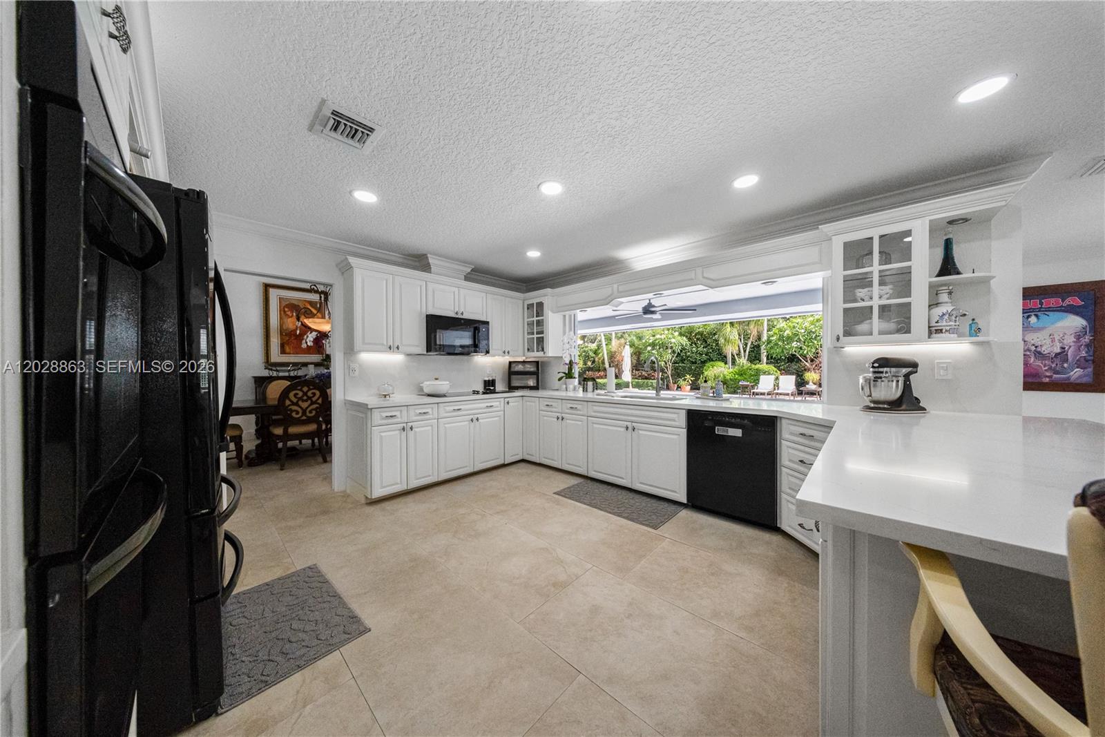 15351 Southwest 146th Street Miami, FL 33196 - Photo 14 of 86 Oversized kitchen with plenty of cabinetry, quartz countertops and backsplash.