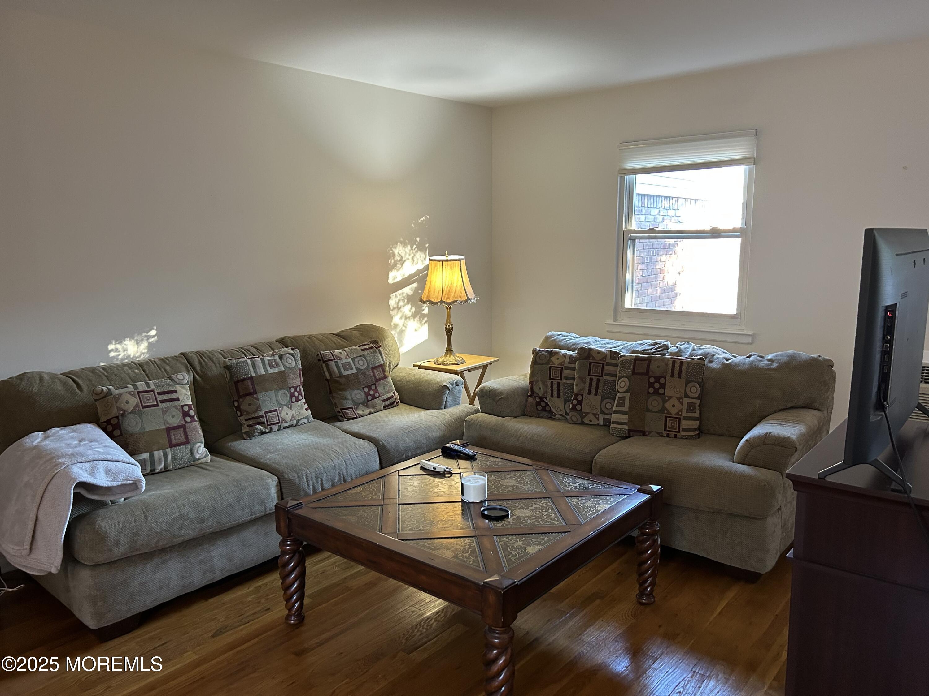 a living room with furniture a rug and a window