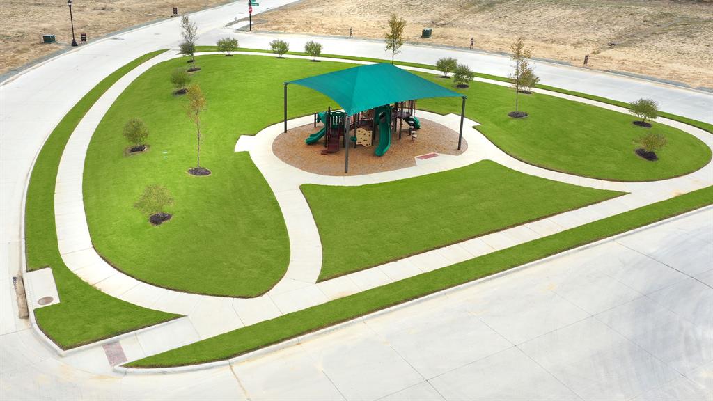 809 Running Iron Trail Mansfield, TX 76063 - Photo 9 of 12 a view of a swimming pool with a chairs and potted plants