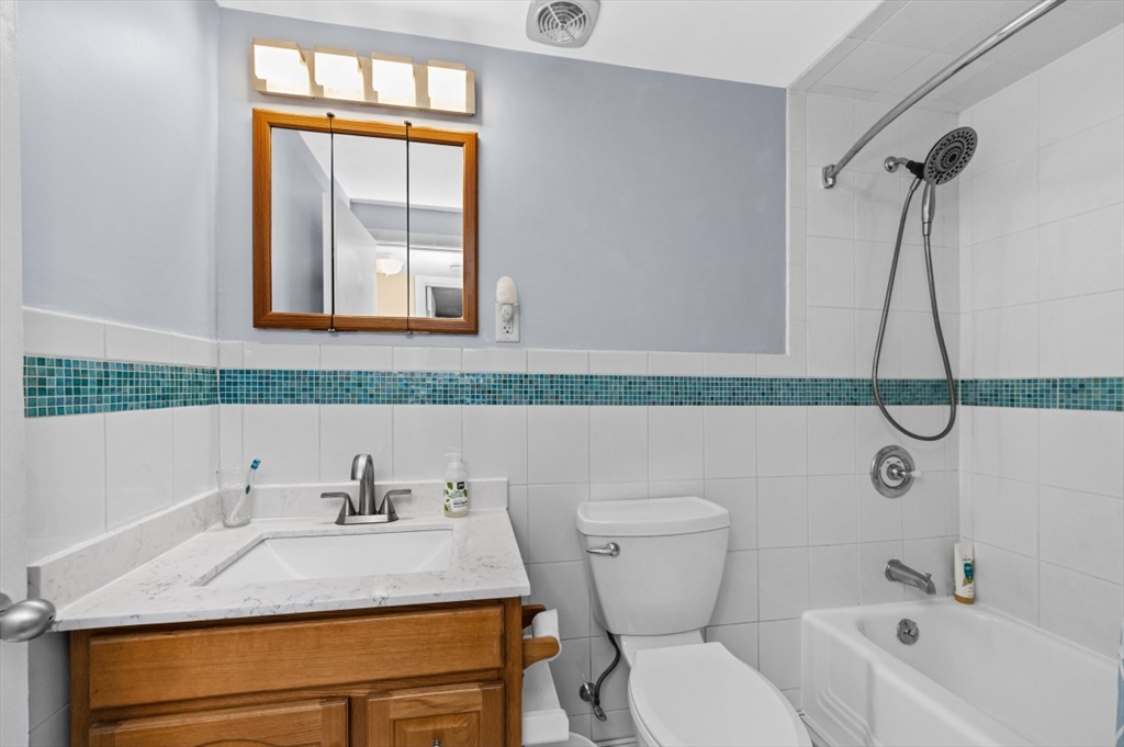 68 Preston Street, Unit 5F Wakefield, MA 01880 - Photo 14 of 20 a bathroom with a granite countertop sink and a mirror