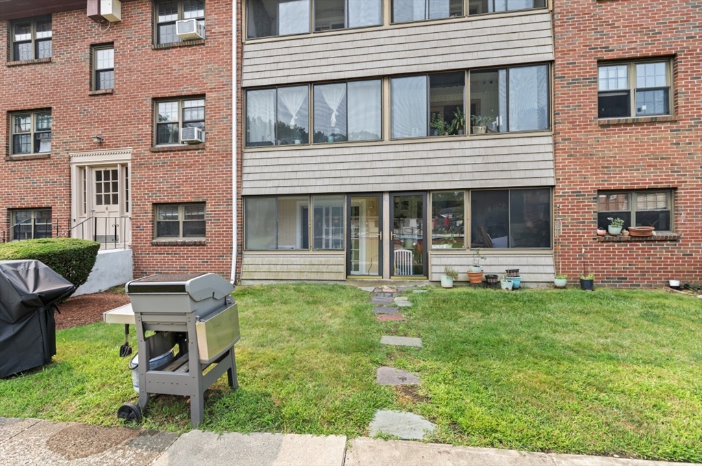 68 Preston Street, Unit 5F Wakefield, MA 01880 - Photo 3 of 20 a front view of a house with a garden
