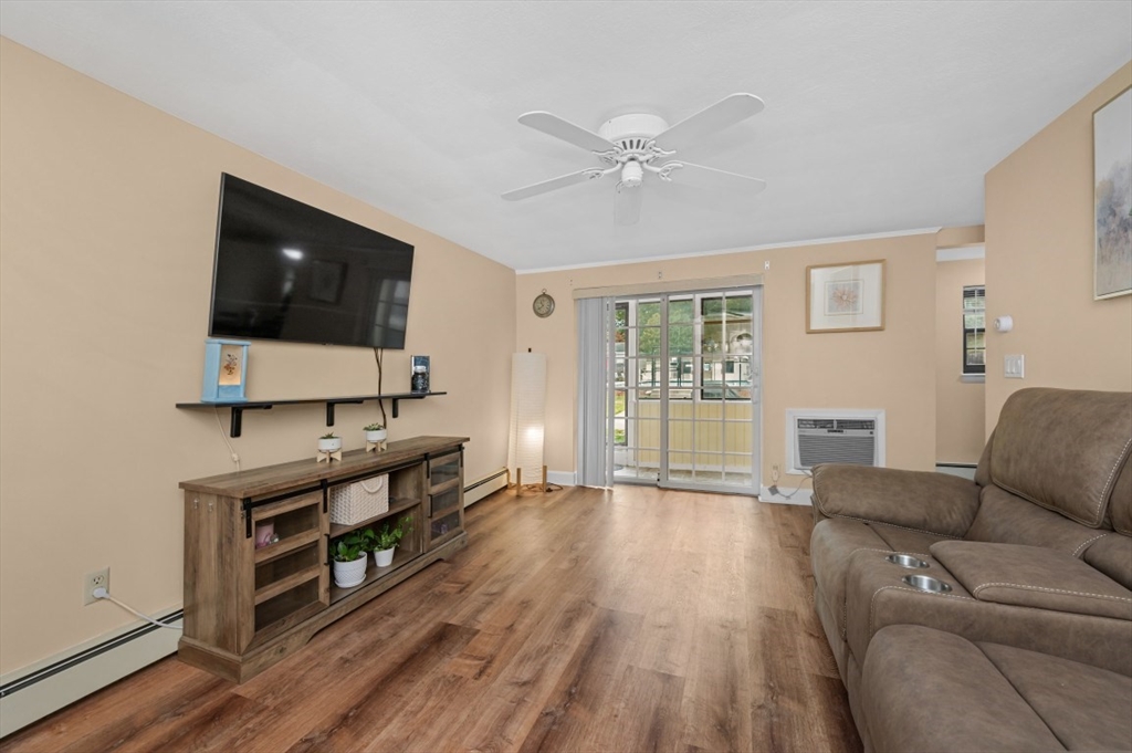 68 Preston Street, Unit 5F Wakefield, MA 01880 - Photo 8 of 20 a living room with furniture and a flat screen tv