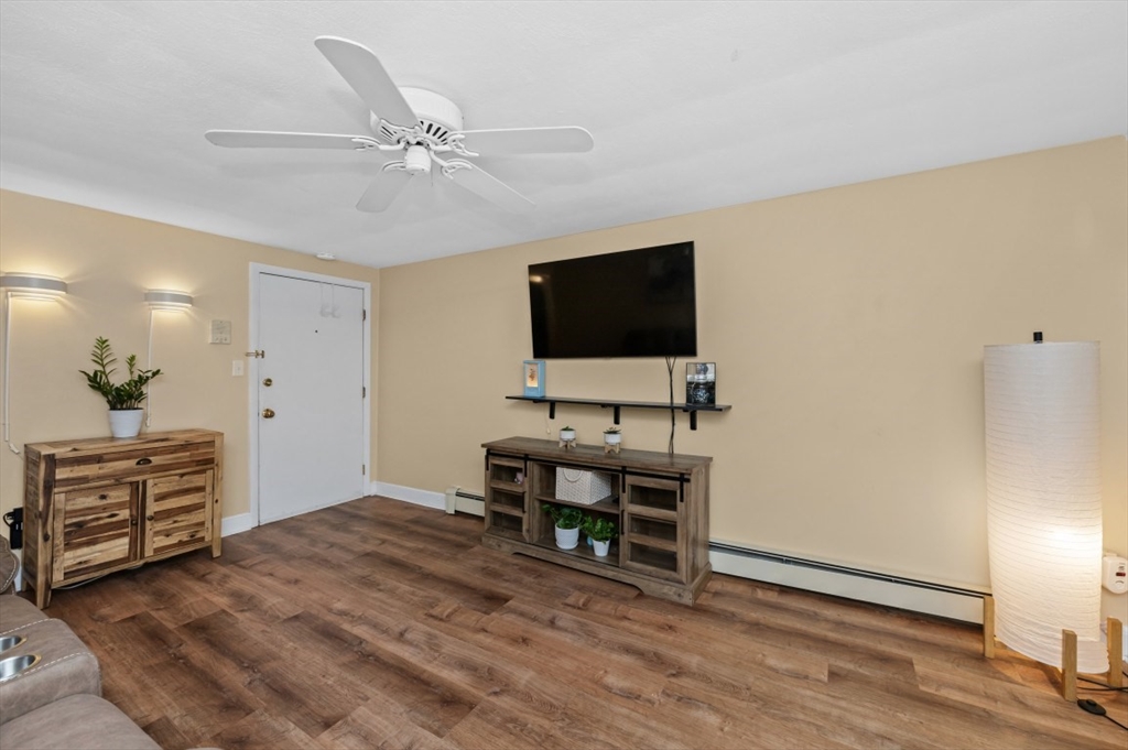 68 Preston Street, Unit 5F Wakefield, MA 01880 - Photo 10 of 20 a view of a livingroom with furniture and a flat screen tv