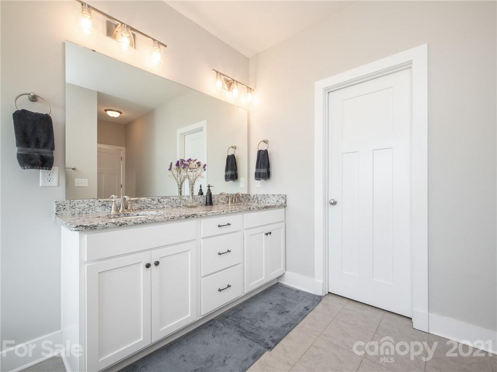 763 Red Spruce Road York, SC 29745 - Photo 24 of 43 a bathroom with a granite countertop sink a mirror and a
