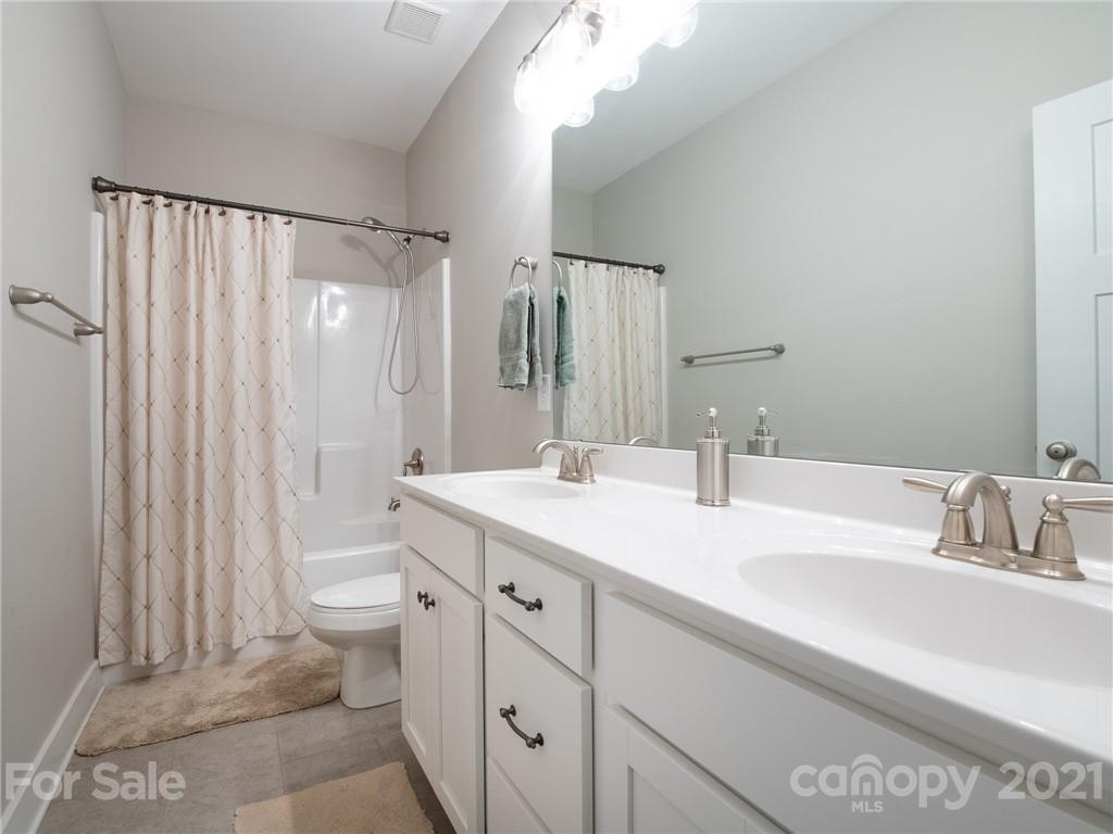 763 Red Spruce Road York, SC 29745 - Photo 27 of 43 a bathroom with a double vanity sink toilet and shower