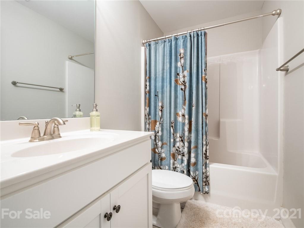 763 Red Spruce Road York, SC 29745 - Photo 29 of 43 a bathroom with a sink a toilet a mirror and shower