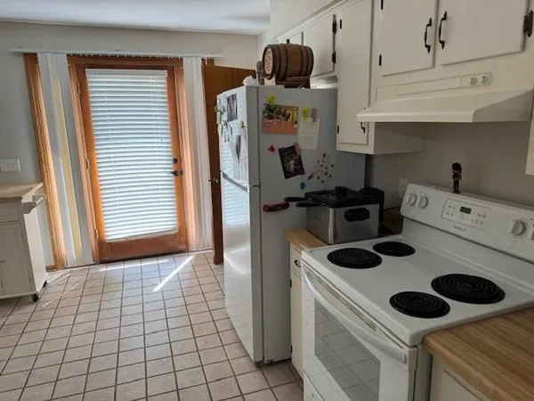 a kitchen with a stove and a refrigerator