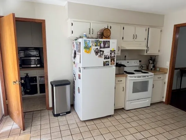 a kitchen with stainless steel appliances a refrigerator sink and cabinets