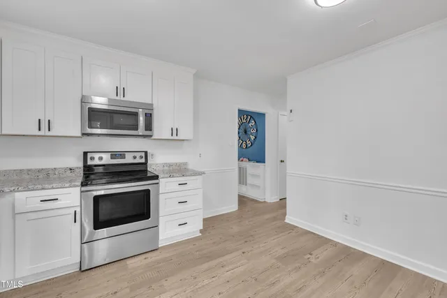 a kitchen with granite countertop a refrigerator and a sink