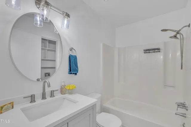 a kitchen with granite countertop white cabinets a stainless steel appliances and a refrigerator