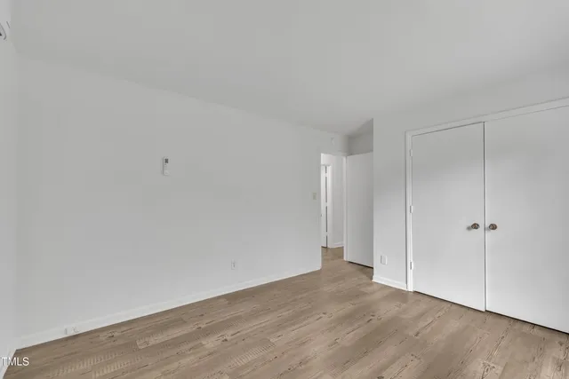 a kitchen with granite countertop white cabinets and stainless steel appliances