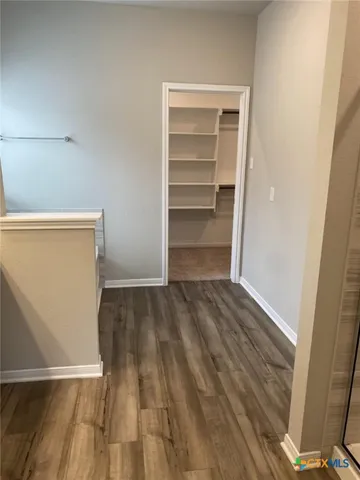 a view of walk in closet with empty racks