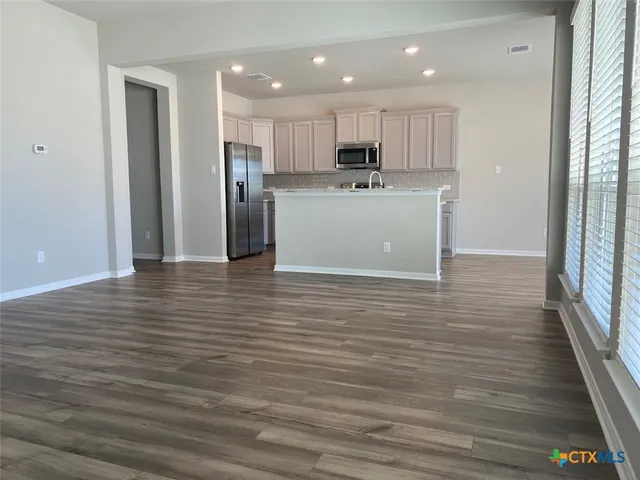 a view of a kitchen from the hallway