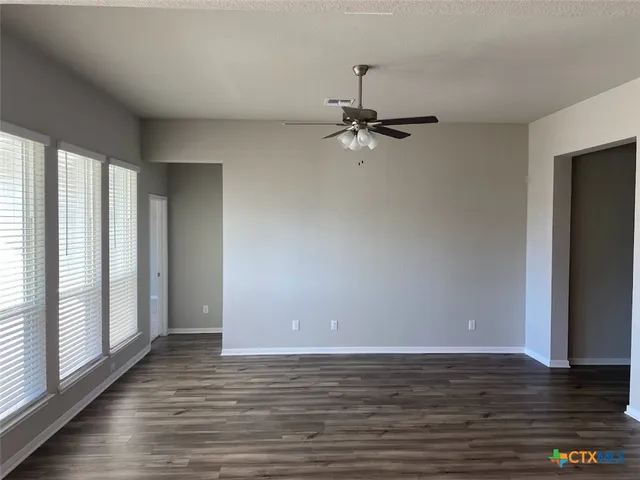 a view of a room with wooden floor and window