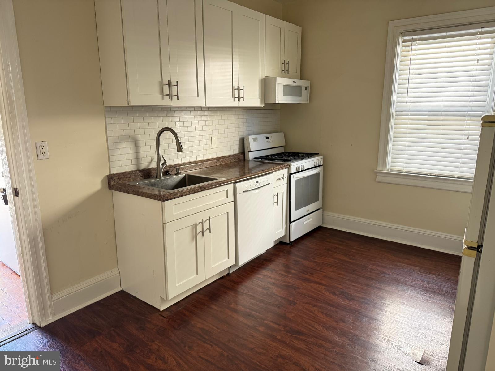 60 Wiggins Street, Unit 1 Princeton, NJ 08540 - Photo 2 of 10 a kitchen with stainless steel appliances granite countertop a sink a stove a microwave and cabinets