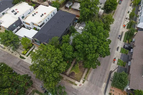 an aerial view of a house with garden space and street view
