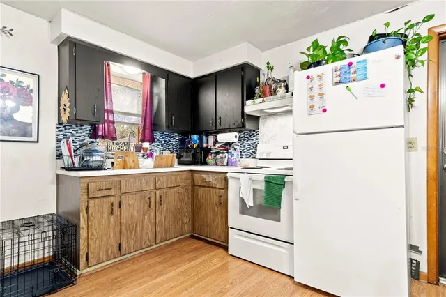 a white refrigerator freezer sitting inside of a kitchen