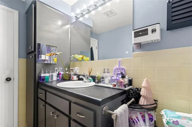 a living room with furniture and a baby crib