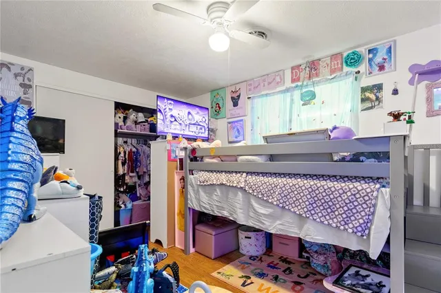 a view of a hallway with wooden floor and workspace