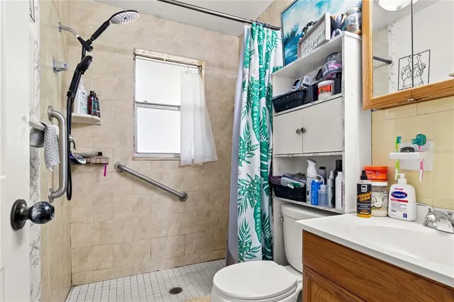 a bathroom with a sink toilet and shower